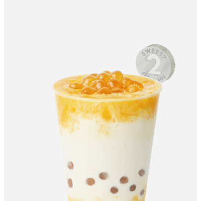 7分甜新創(chuàng)新水果奶茶，芒果果肉加入香濃牛奶，
配上清香白桃烏龍茶，Q彈珍珠增加咀嚼口感，唇齒意猶未盡